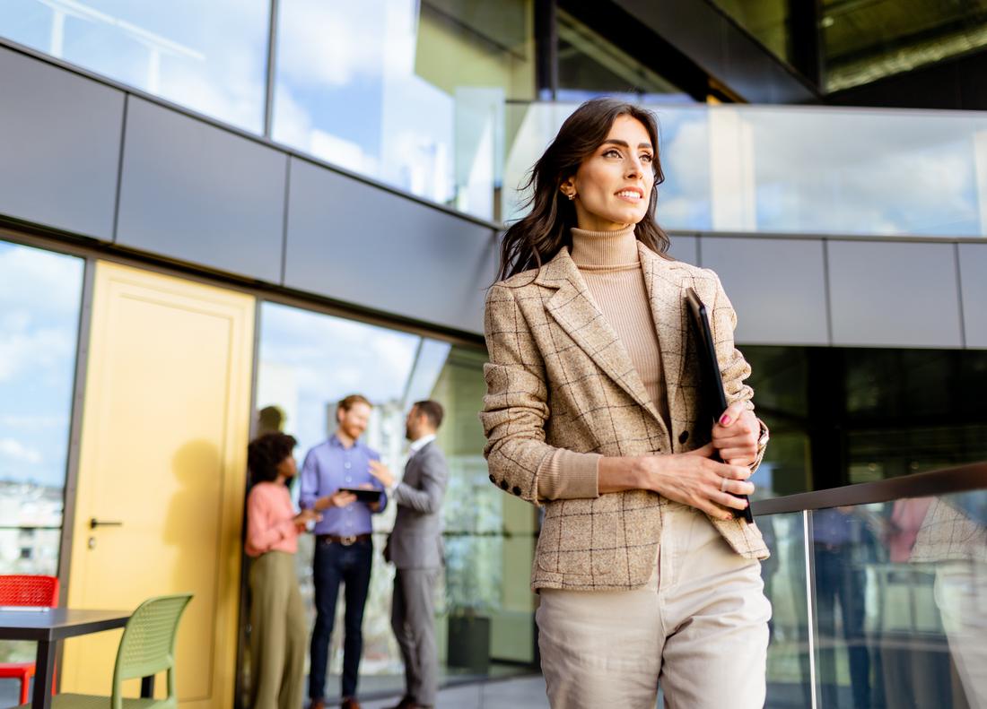 An attorney walking between meetings, laptop in hand