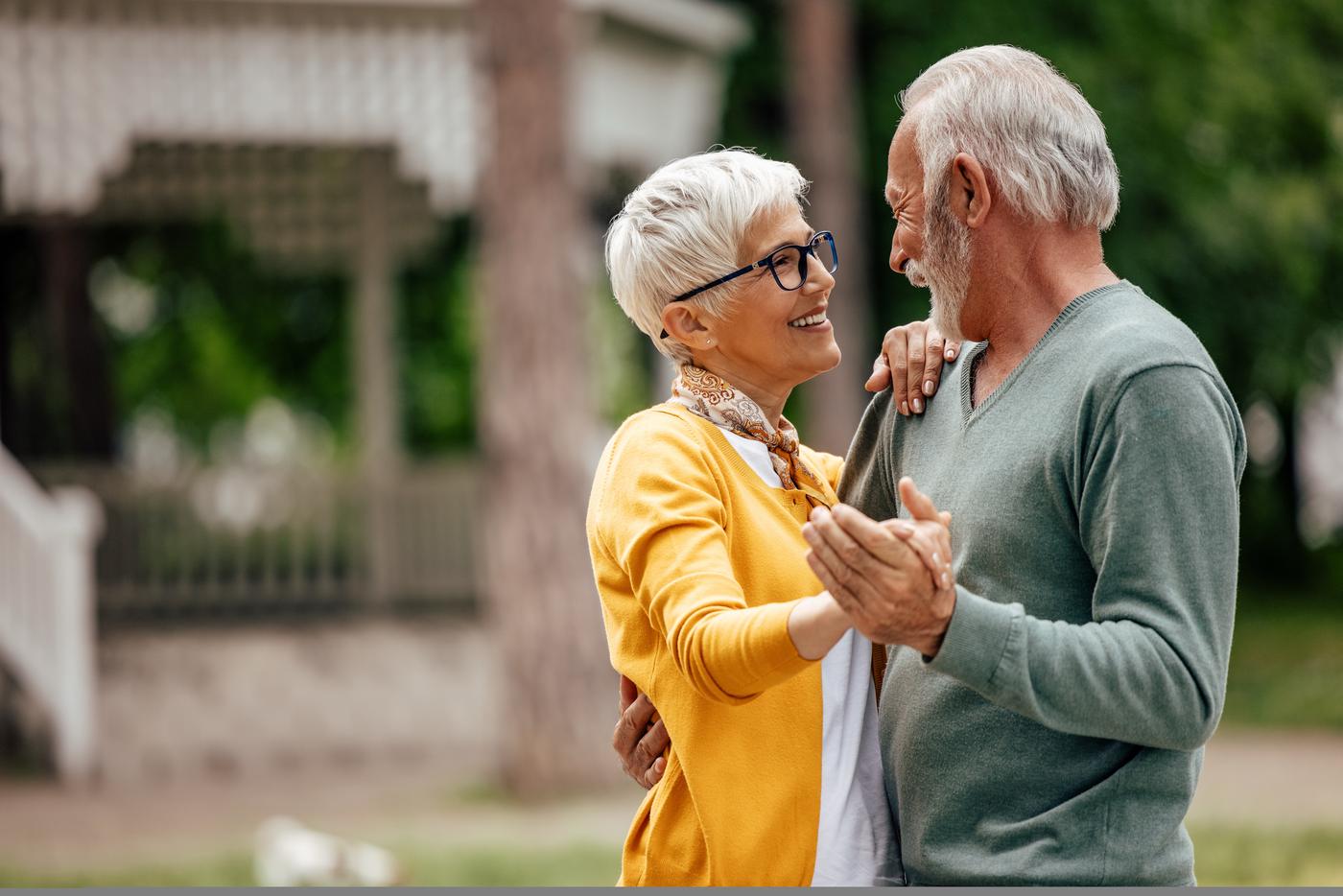 Susan dancing with her husband in the park, laughing