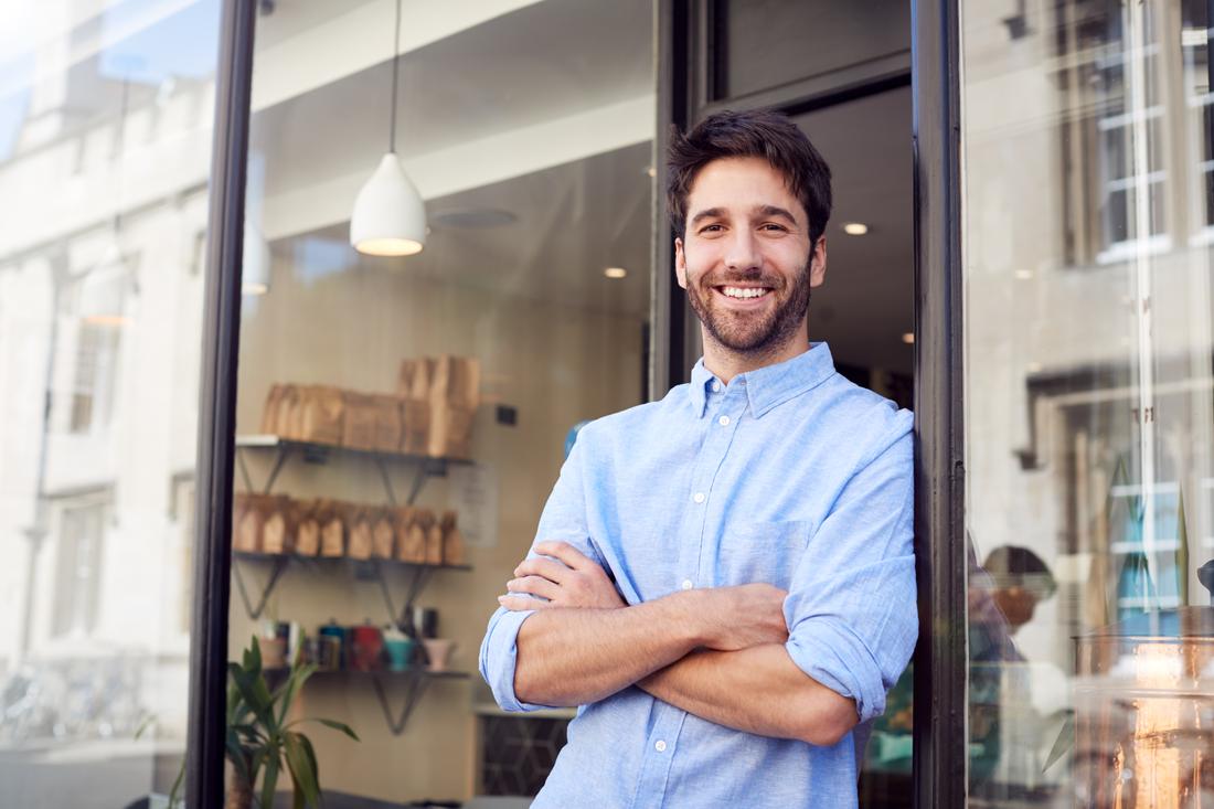 A business owner standing in the doorway of the shop he built